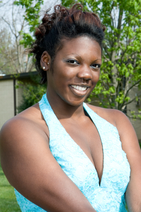 Young woman wears turquoise sparkling halterneck party dress